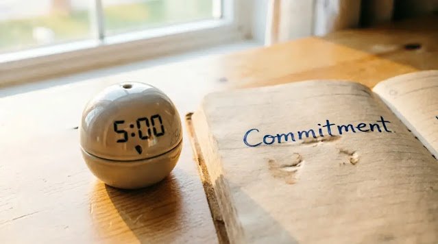 Kitchen timer five minutes open notebook wooden table single word (AI-generated illustration)