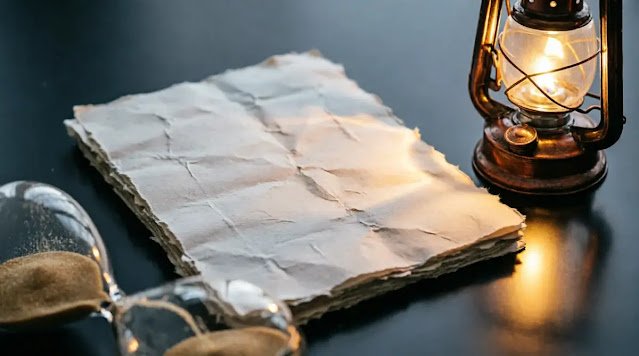 Fractured hourglass on blank pages, brass lantern flame, paper casting sand-textured shadow despite smooth surface, atmospheric haze(AI-generated illustration)