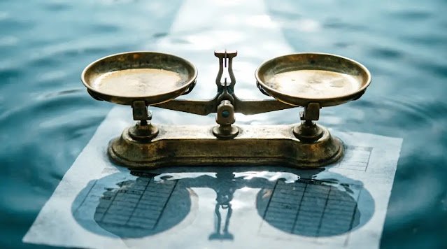 Brass scale casting directional compass shadow, faint checklist, rippled water, cool light(AI-generated illustration)