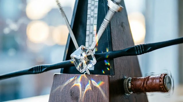 Autonomous swinging metronome, vibrating gear knob, rubber band tension waves, soft volumetric light (AI-generated illustration)